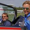 Gerald Cooper aerobatic pilot in Extra, Sarah standing beside, both wearing Bigatmo pilot sunglasses.