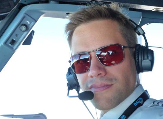 Commercial pilot wearing Bigatmo Iono photochromic sunglasses with ANR headset