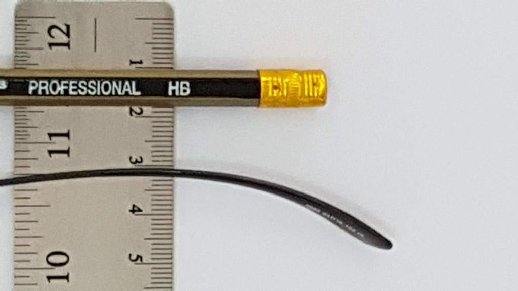 Image of a temple next to a pencil on a ruler,showing thickness of temple at 2mm.