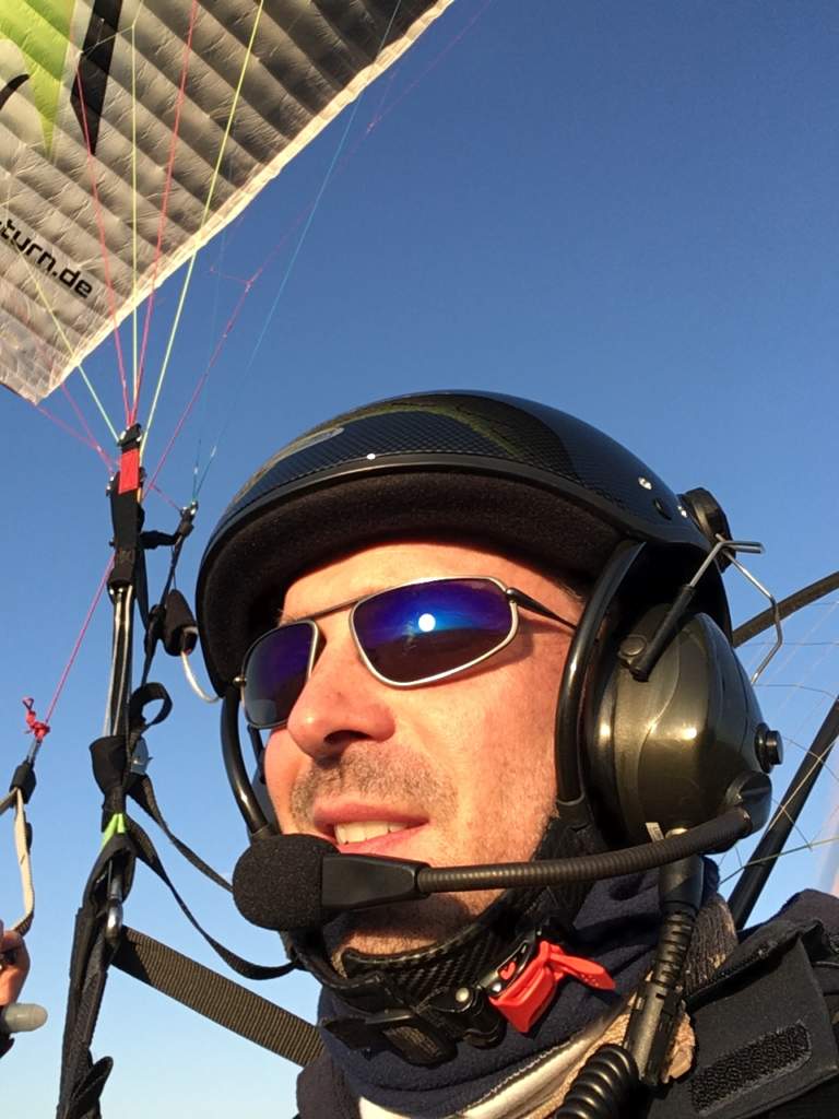 Man wearing Bigatmo sunglasses whilst power paragliding