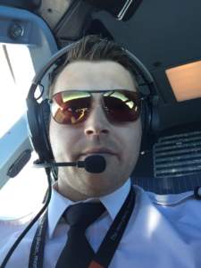 Commercial airline pilot wearing Bigatmo sunglasses sitting in the flightdeck of an airbus